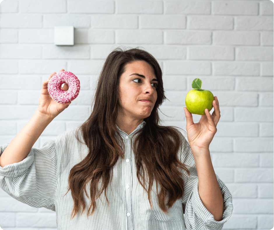Titelbild mit Frau, die Donut in der einen und einen Apfel in der anderen hält. Dabei schaut sie den Apfel unentschlossen an.